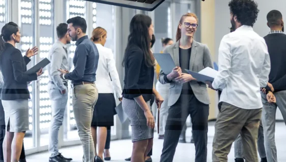 A collaborative global business team working together on a strategic plan with world maps and data charts, showcasing their expertise in guiding businesses to enter and succeed in international markets.