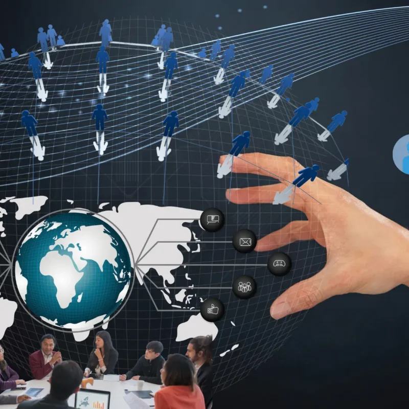 A diverse, multicultural team collaborating around a table with a world map and digital tools, representing the strength and synergy of a global team driving innovation and results.